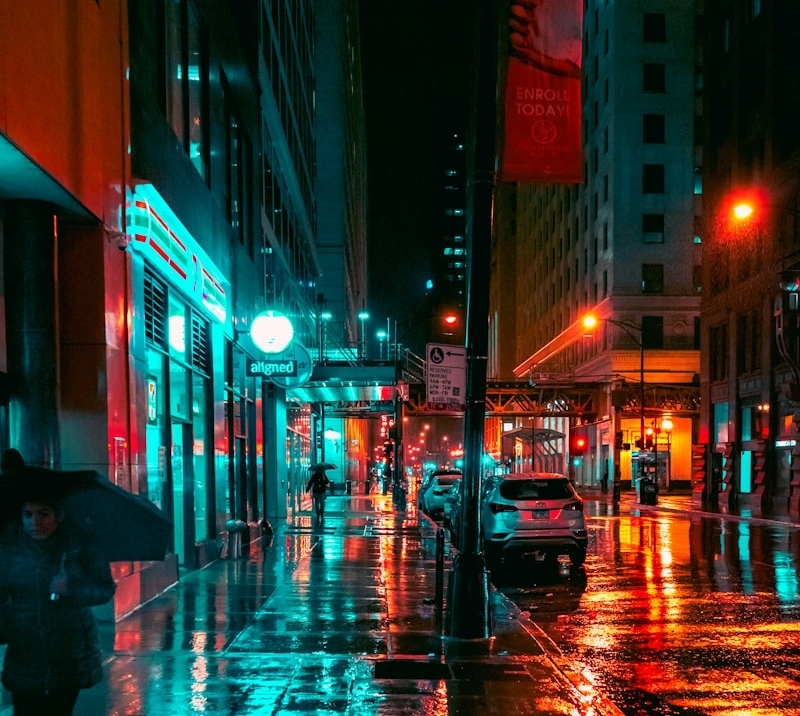 a person walking down a street holding an umbrella